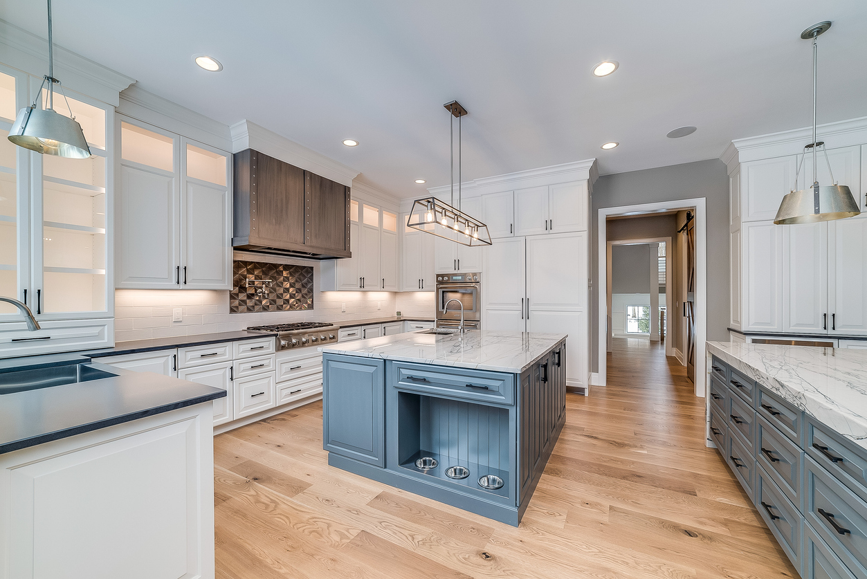 Newark, CA home with Large kitchen with island surrounded by white quartzite countertops with freshly painted kitchen cabinets